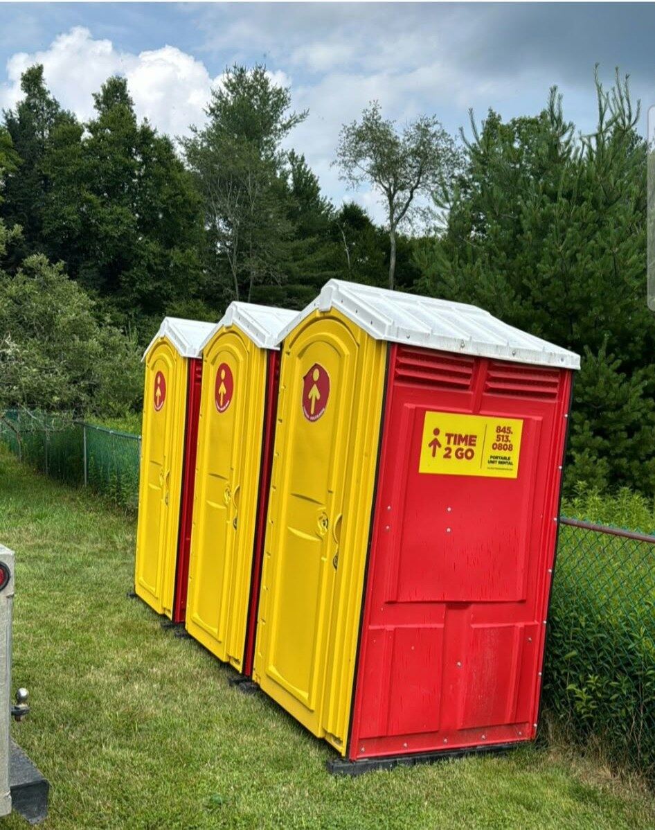 Red and yellow Time2go portable toilet units